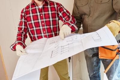 Stock Image of People with Blueprints